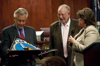 Mayor Pro-Tem Gary Reese, at left, receives a flag of the City of Las Vegas from City Manager Elizabeth Fretwell during a recognition ceremony to honor his service June 15, 2011. 